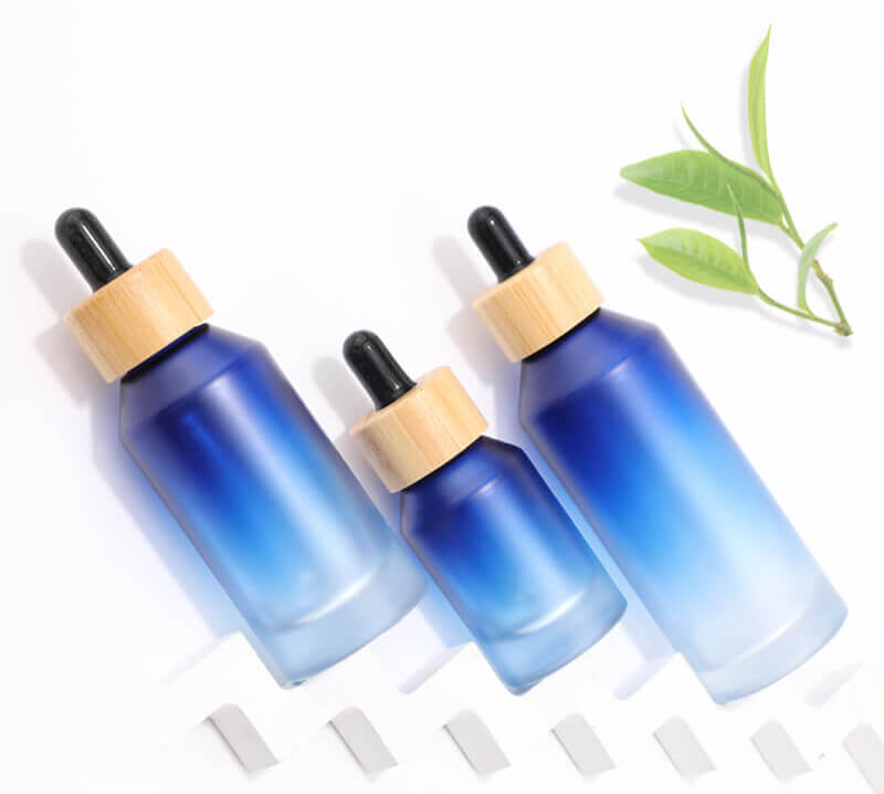 Gradient blue glass bottle with bamboo dropper for cosmetic packaging