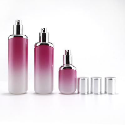 Luxury color gradual skincare cosmetic glass bottle/jar sets with silver lotion pump and lid