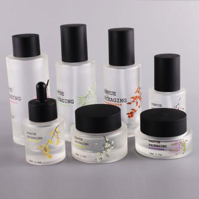 Embossed flat shoulder cosmetic glass bottle jar set